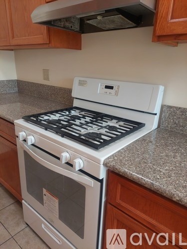 A white stove top oven with four burners and a white oven below it.