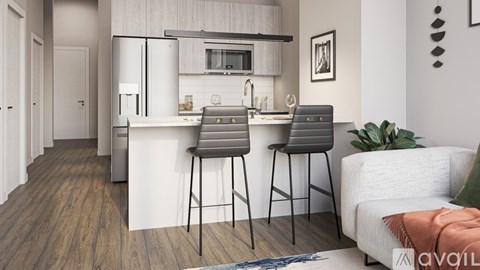 A modern kitchen with a bar stool and a white sofa.