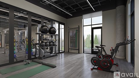 A gym with a variety of equipment including a treadmill, weights, and a yoga mat.