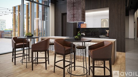 A modern bar area with brown leather chairs and a wooden table.