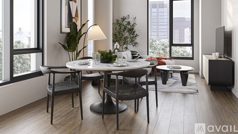 A modern dining room with a table set for two and a television.