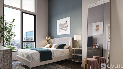 A bedroom with a large bed and a view of the city.