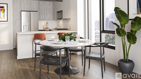 A modern kitchen with a dining table set for two.
