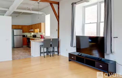 A modern living room with a television and a bar area.