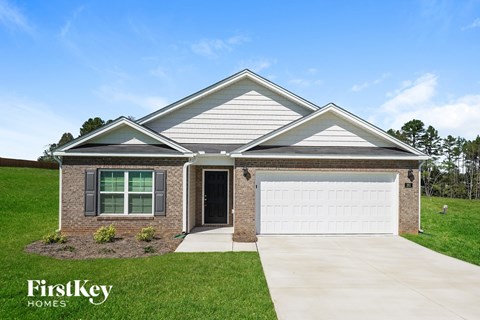A house with a garage and a driveway is shown.