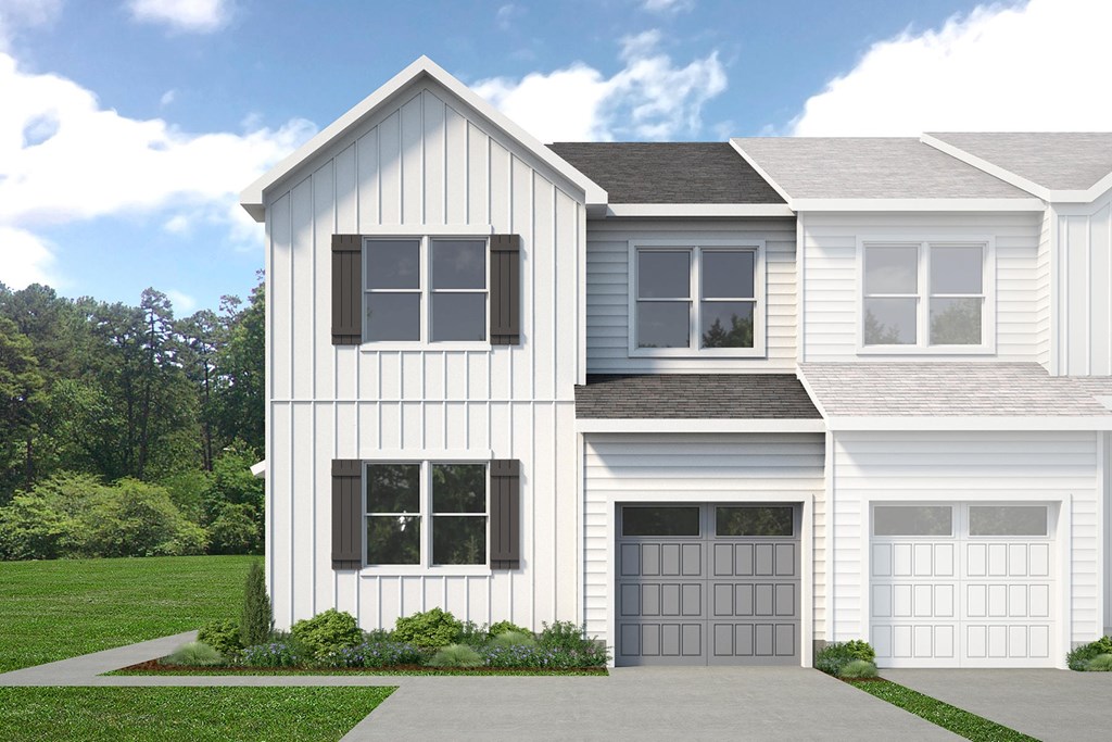 A two-story house with a white exterior and a grey garage door.