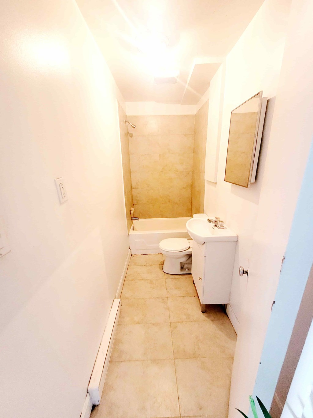 A bathroom with a toilet, sink, and shower.