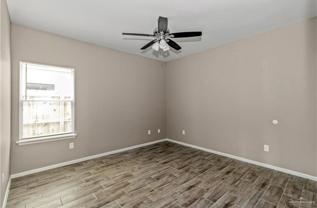 A room with a ceiling fan and a window.