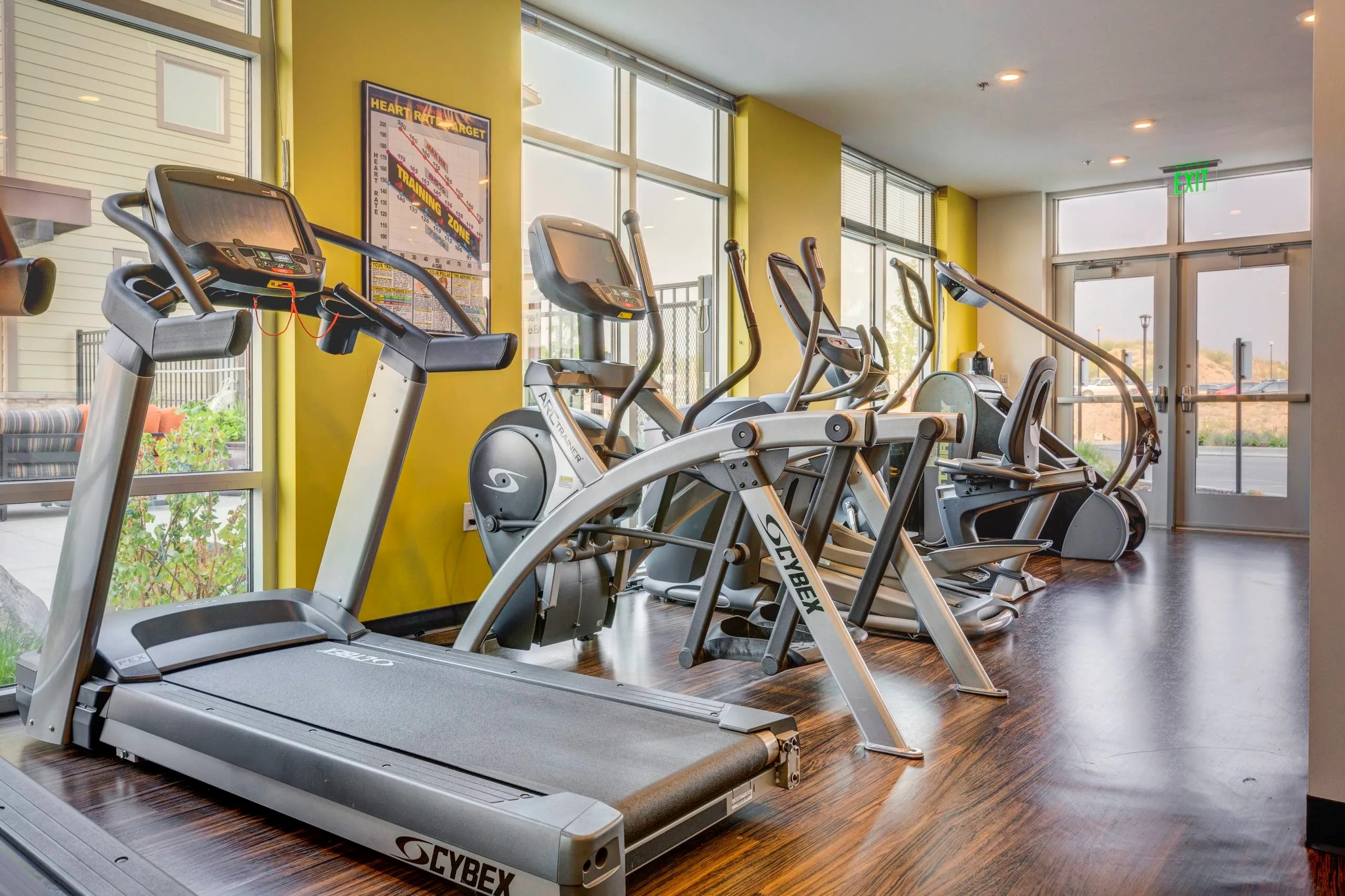 A gym with treadmills and elliptical machines.