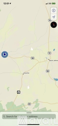 A map application is open on a phone screen, showing a location marker and a search bar.