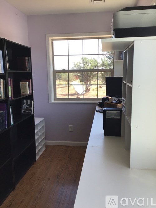 A room with a window and a bookshelf.