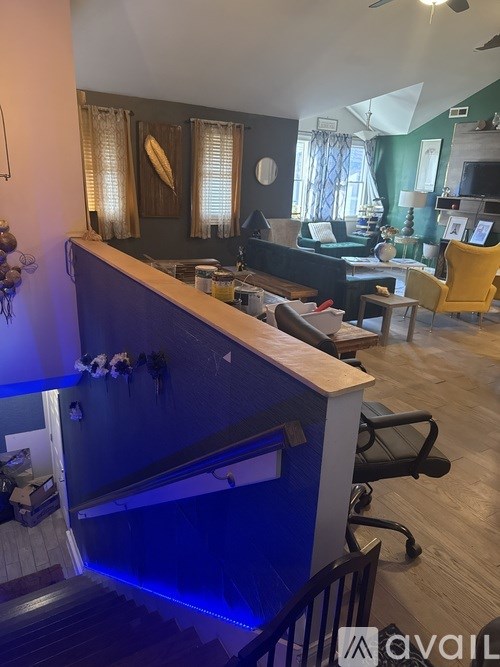 A room with a blue bar counter and a yellow chair.