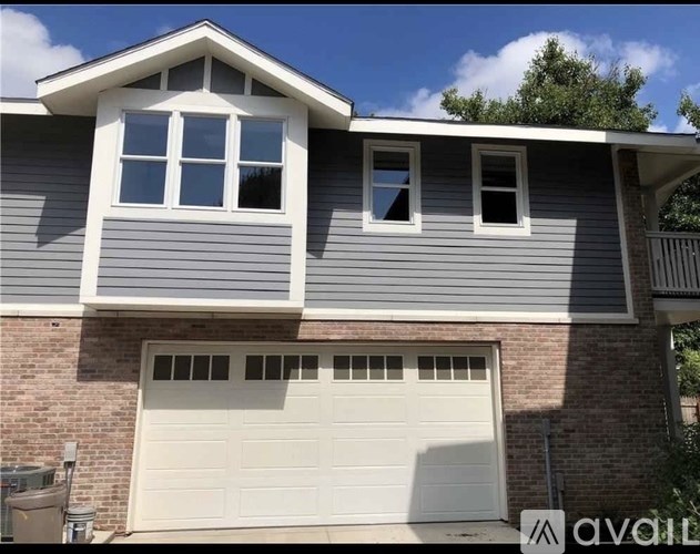A house with a garage door and a window.