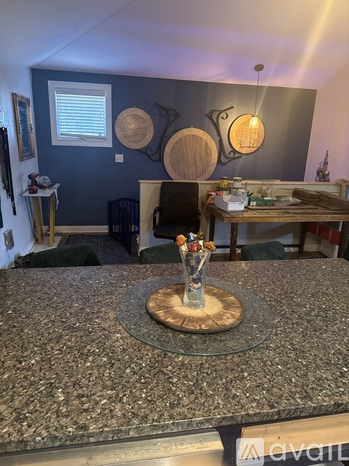 A kitchen island with a wooden base and a granite countertop.