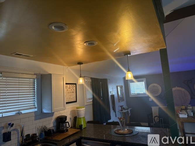 A kitchen with a counter and a coffee maker.