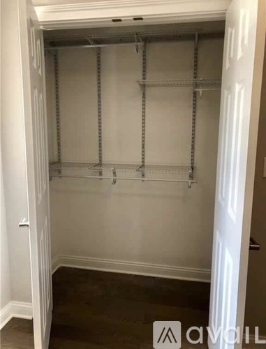 A white closet with shelves and a door.