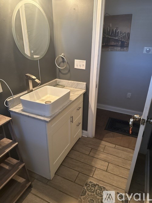 A bathroom with a sink and mirror.
