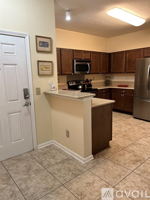 A kitchen with a white door and a white counter.
