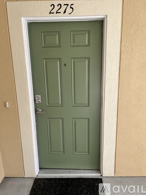 A green door with the number 2275 above it.
