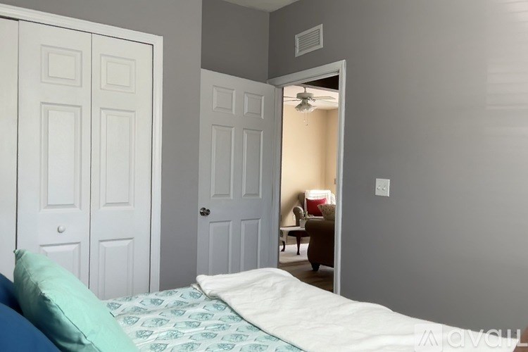 A bedroom with a bed and a door.