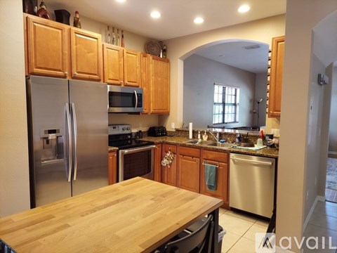 A kitchen with wooden cabinets and stainless steel appliances.