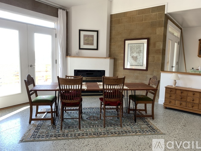 A dining room with a table and chairs.