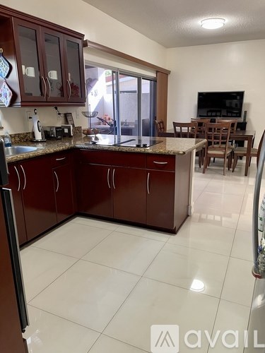 A kitchen with brown cabinets and a white countertop.