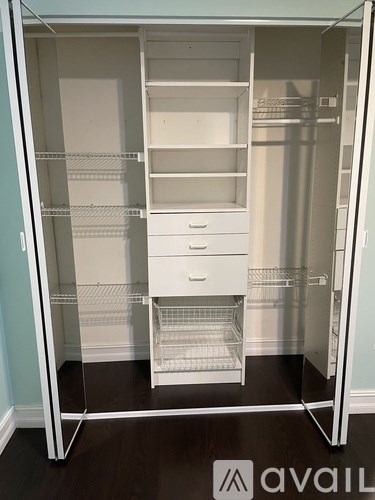 A white, empty, two-door stand-up refrigerator with a white interior.