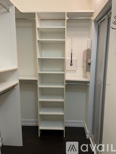 A white shelving unit with a ladder in the middle.