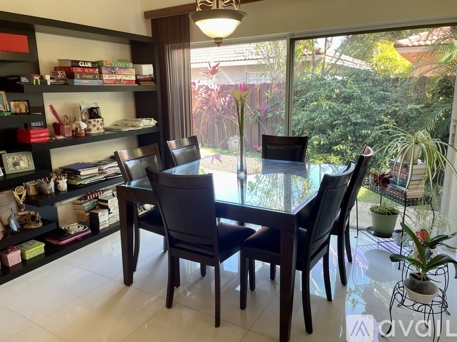 A dining room with a glass table and chairs.