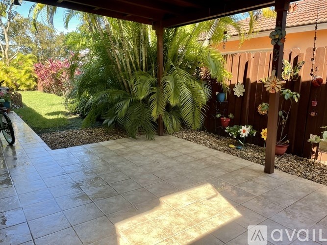 A patio with a tile floor and a wooden fence.