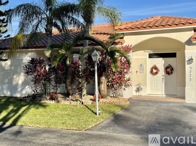 A house with a white door and a wreath on it.