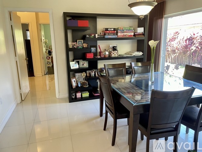 A dining room with a glass table and chairs.