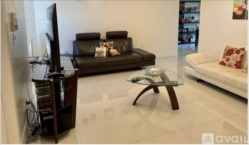 A dining room with a table and chairs.