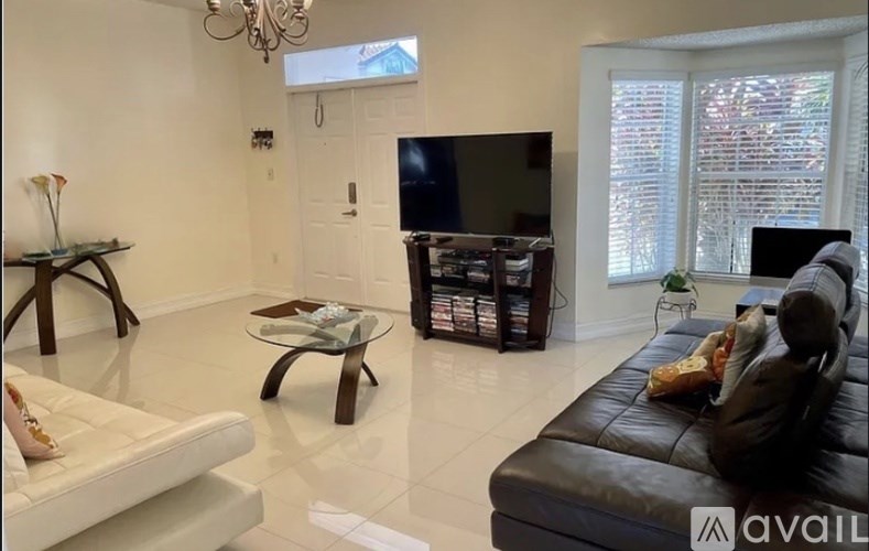 A hallway with a table and chairs in the background.