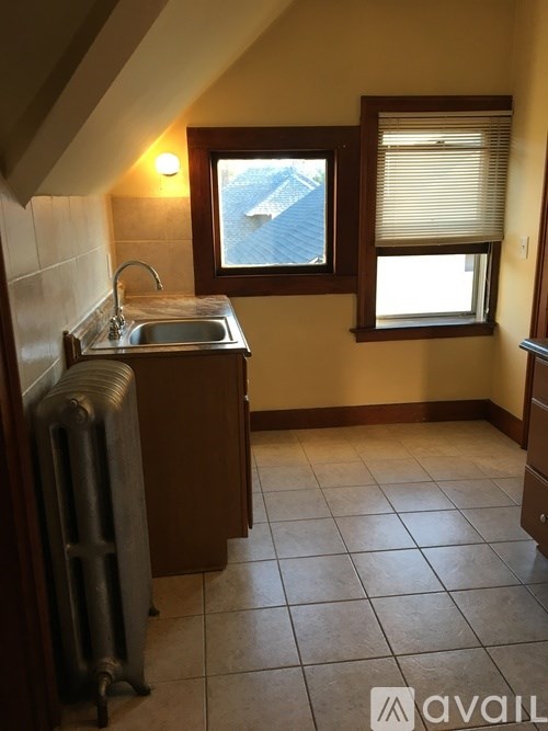 A small room with a window and a sink.