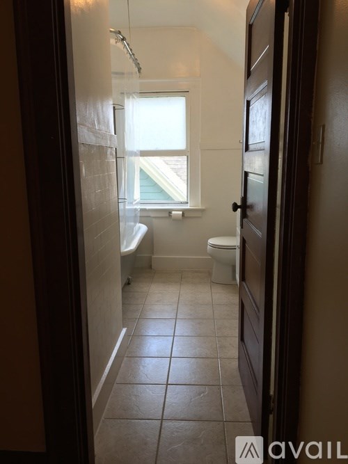 A bathroom with a toilet, sink, and shower.
