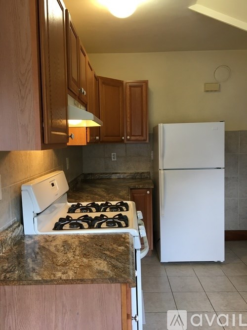 A kitchen with a white fridge and a white stove.