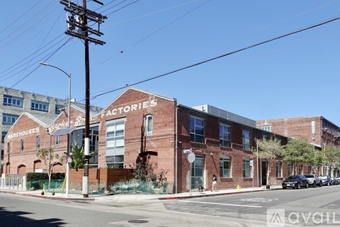 A street view of a brick building with the words "Factories" and "Warehouses" on it.