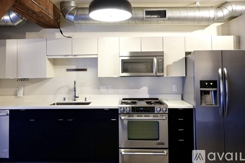 A kitchen with a black countertop and stove.