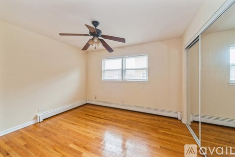 A room with a ceiling fan and a window.