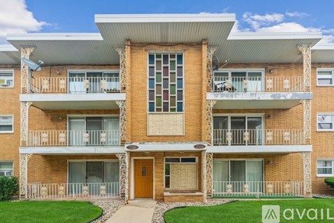 A large brick building with a balcony on the second floor.