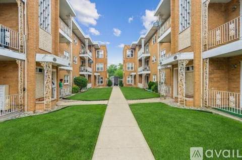 A row of apartment buildings with a walkway in the middle.