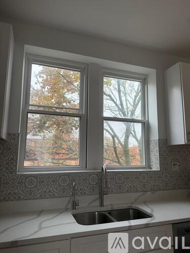 A kitchen with a sink and a window.