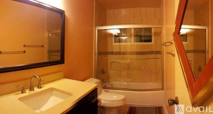 A bathroom with a sink, toilet, and shower.