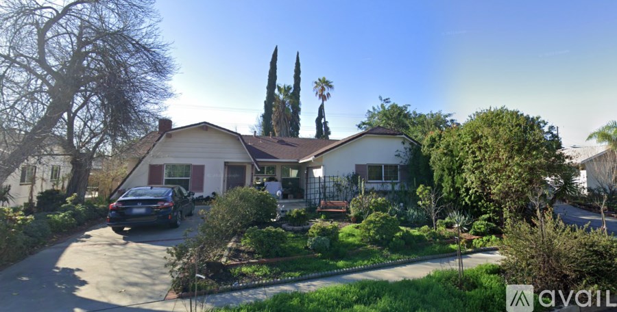 A house with a car parked in front of it.