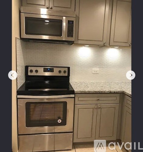 A kitchen with a stove top oven and microwave above it.