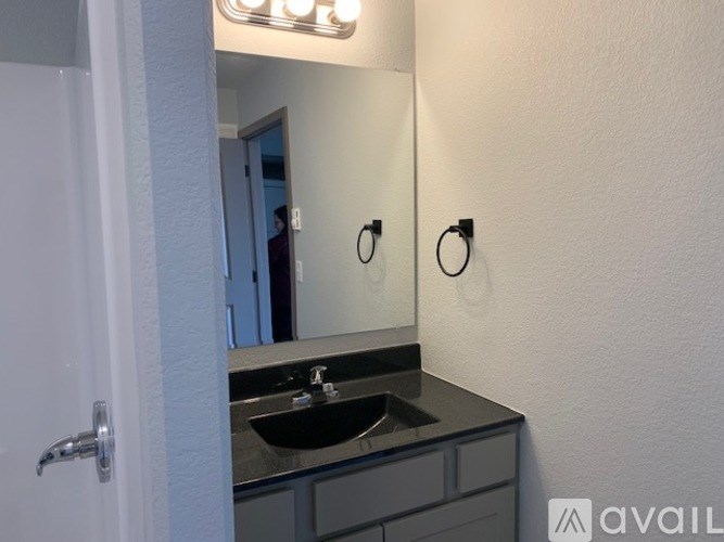 A bathroom with a sink and mirror.
