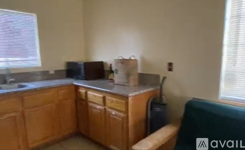 A kitchen with wooden cabinets and a countertop.