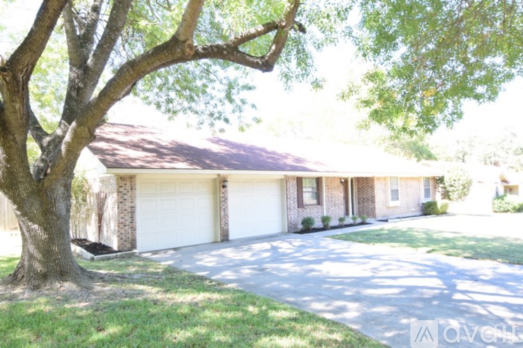 A house with a tree in front of it.